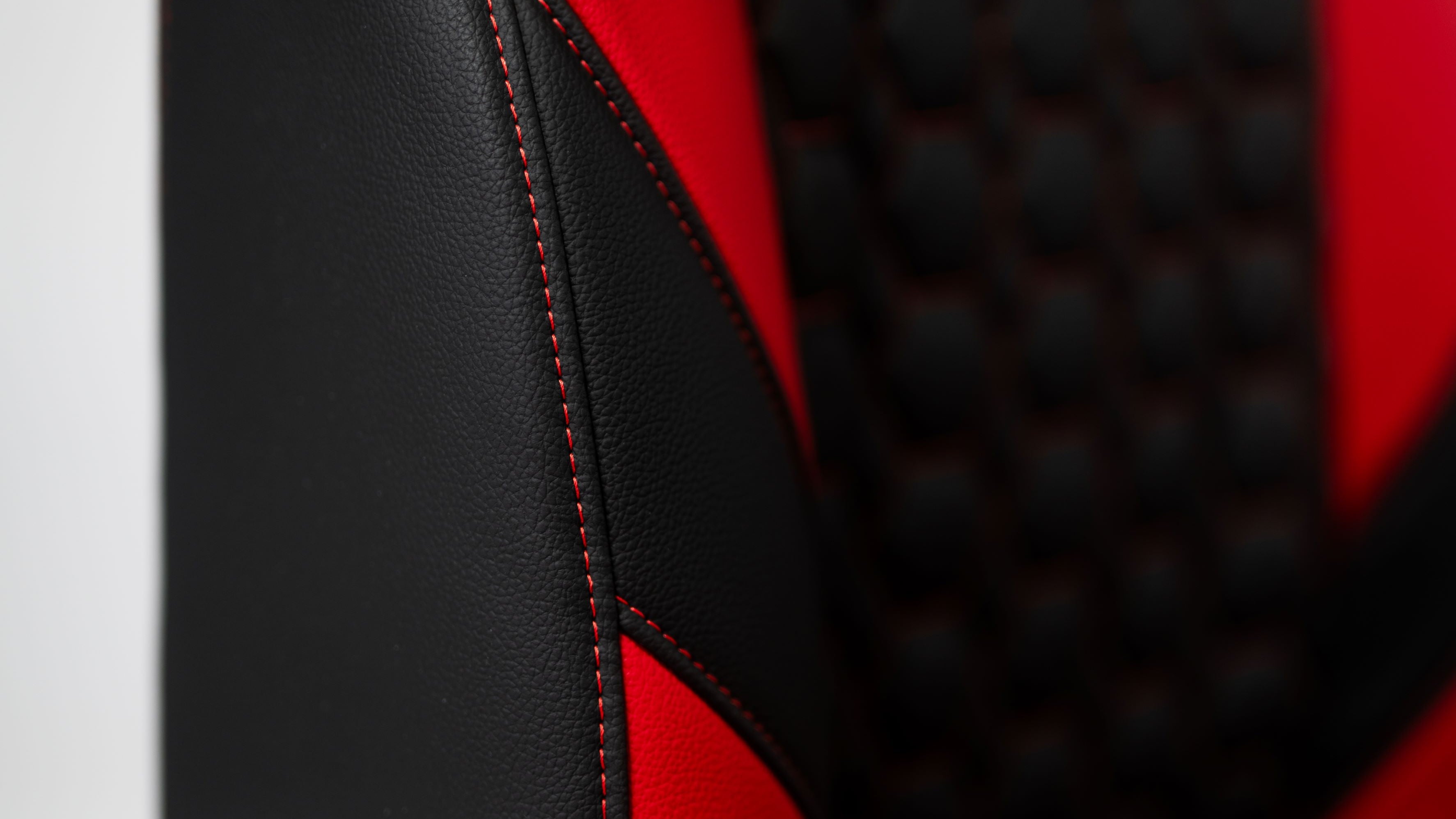 Kratos Pro 4D Throne V2 Vengeance showing side cushion and red switching in detail