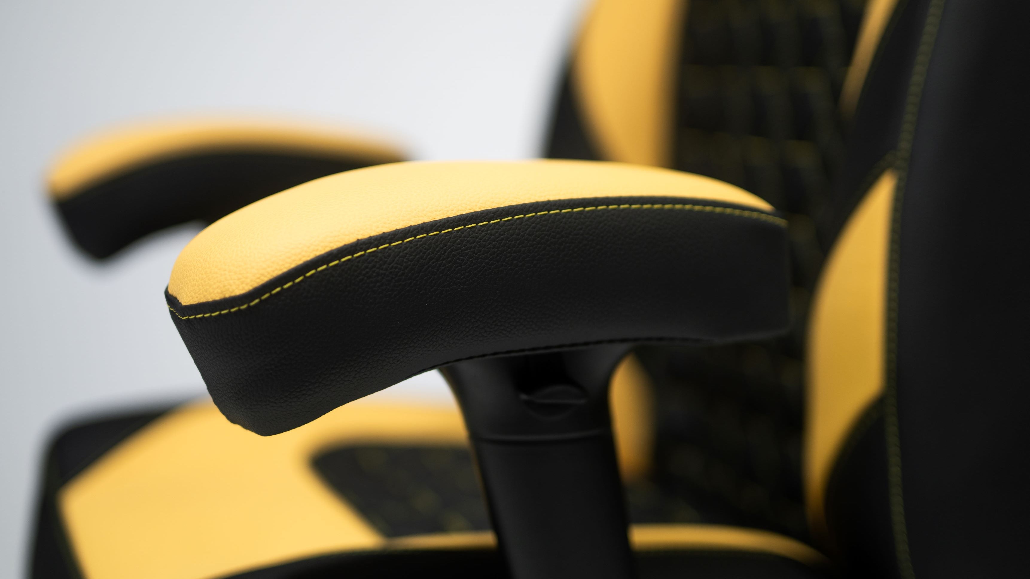 Yellow and Black Gaming chair Armrest Close up.