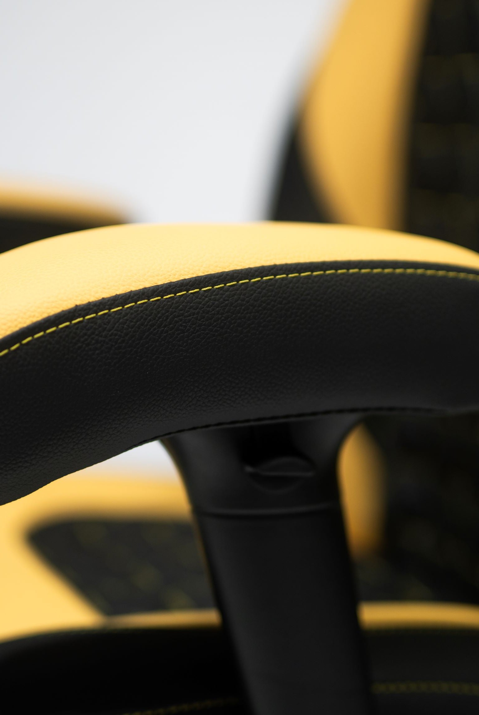 Yellow and Black Gaming chair Armrest Close up.