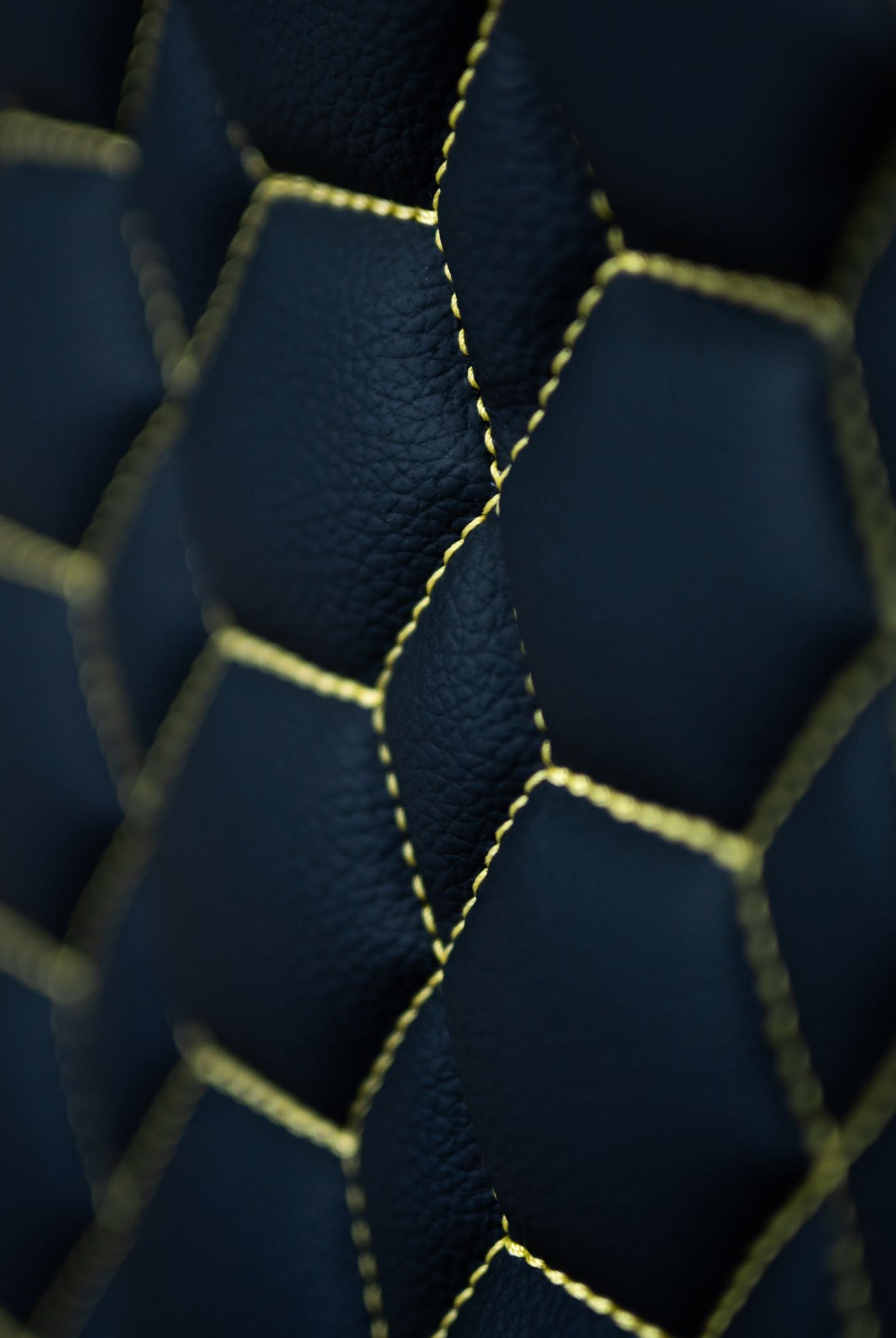 Close up stitching of a yellow and black gaming chair Kratos Pro 4D Throne V2