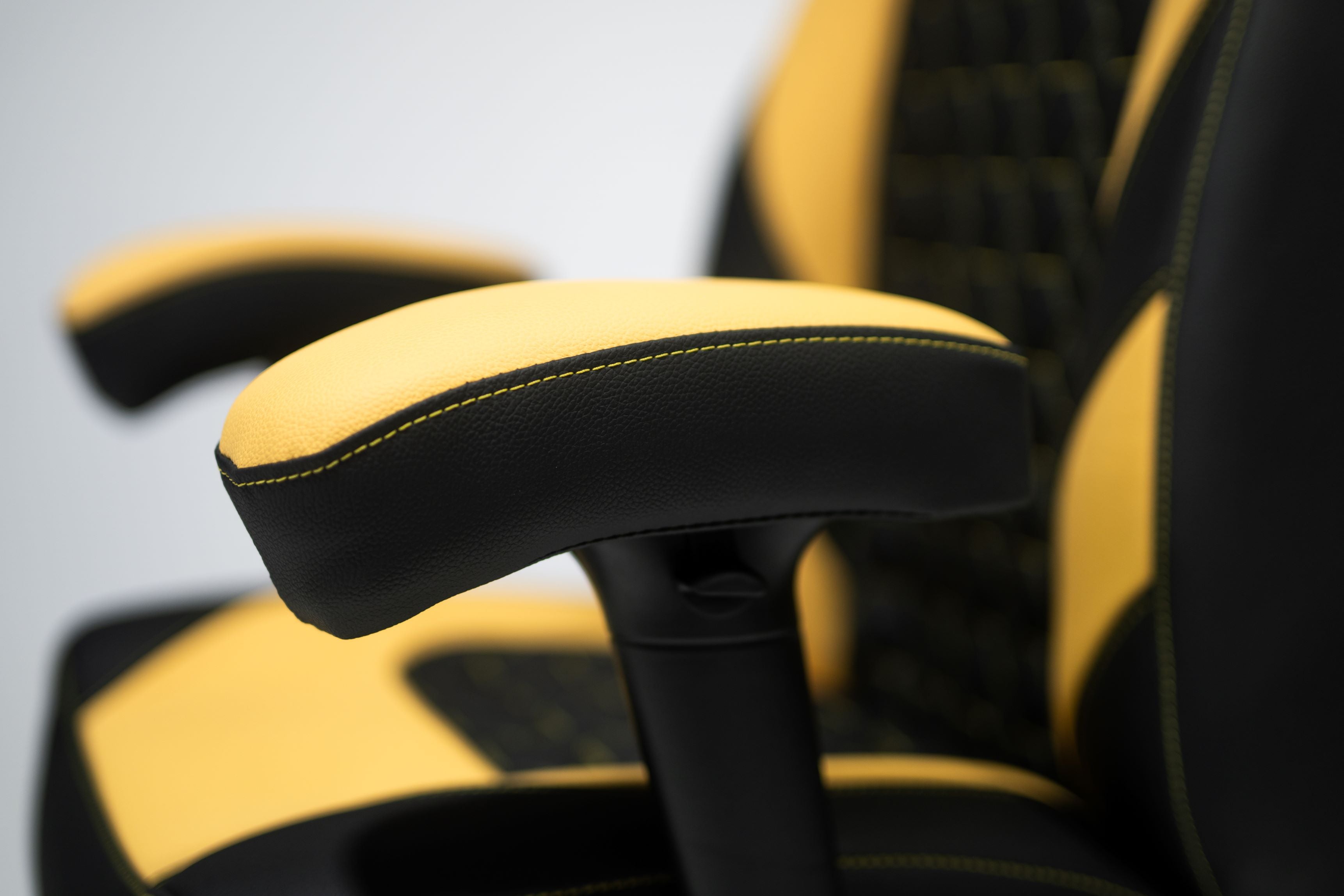 Yellow and Black Gaming chair Armrest Close up.